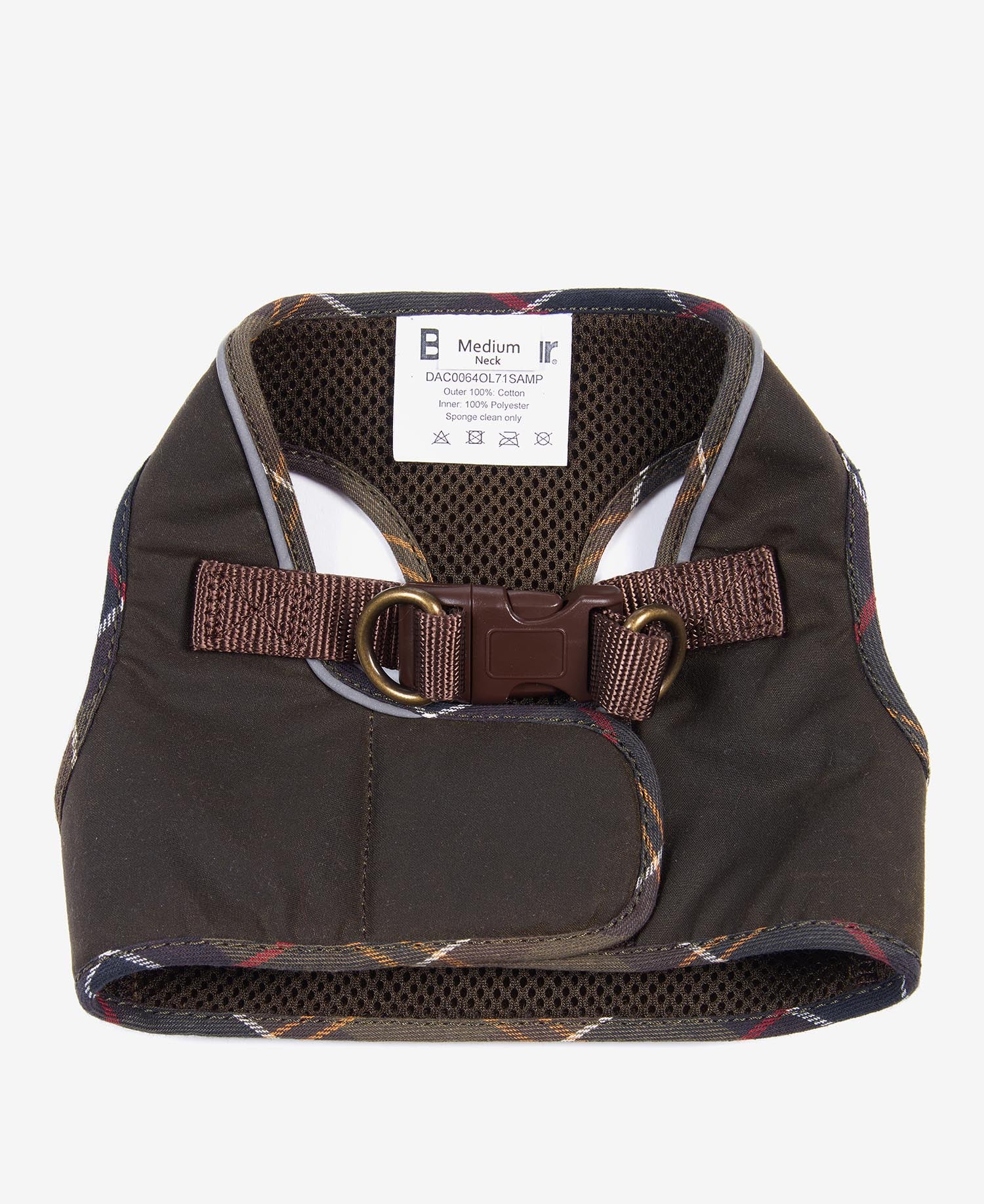 Waxed olive green step-in dog harness laid flat on a wooden surface with autumn leaves
